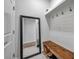 Mudroom offers bench seating, shelving, hooks, mirror and wood-look flooring at 12280 Lyon Pine Ln, Odessa, FL 33556