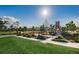 Scenic view of a community playground featuring modern equipment, mature trees, and a paved walkway at 12280 Lyon Pine Ln, Odessa, FL 33556