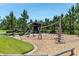 Fun community playground with various climbing structures, swings, and a covered seating area surrounded by trees at 12280 Lyon Pine Ln, Odessa, FL 33556