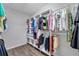 Spacious walk-in closet with custom shelving, hanging rods, and ample storage space for clothes and accessories at 12280 Lyon Pine Ln, Odessa, FL 33556