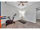 This room boasts a treadmill, stationary bike, pull-up bar, and neutral walls with wood flooring at 12280 Lyon Pine Ln, Odessa, FL 33556