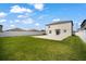 Spacious backyard with a concrete patio, green grass, and a vinyl fence at 13227 Great Plains Dr, Riverview, FL 33579