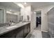 Bathroom features a granite countertop, double vanity sinks and a linen closet at 13227 Great Plains Dr, Riverview, FL 33579