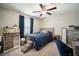 Comfortable bedroom features a ceiling fan, large window, and blue accents at 13227 Great Plains Dr, Riverview, FL 33579