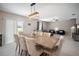 Bright dining room with tile floors, decorative lighting, seating for six, and access to the living room at 13227 Great Plains Dr, Riverview, FL 33579
