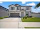 Two-story home with manicured lawn, gray shutters, and a two-car garage at 13227 Great Plains Dr, Riverview, FL 33579