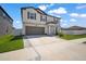 Two-story home with a two-car garage and green landscaping at 13227 Great Plains Dr, Riverview, FL 33579