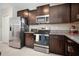 This stunning kitchen features stainless steel appliances, granite countertops, and ample cabinet space at 13227 Great Plains Dr, Riverview, FL 33579