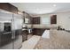 Stylish kitchen boasts stainless steel appliances, dark wood cabinets, and granite countertops for a modern look at 13227 Great Plains Dr, Riverview, FL 33579