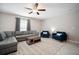 Inviting living room with ceiling fan, ample seating, neutral tones, and natural light from the window at 13227 Great Plains Dr, Riverview, FL 33579