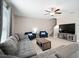 Spacious living room with tile floors, ceiling fan, comfortable seating, and staircase access at 13227 Great Plains Dr, Riverview, FL 33579