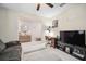 Comfortable living room featuring tile floors, ceiling fan, modern furniture, and neutral paint colors at 13227 Great Plains Dr, Riverview, FL 33579