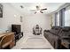 Comfortable living room with a sofa, media center, and a ceiling fan at 13227 Great Plains Dr, Riverview, FL 33579