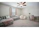 Comfortable living room features a plush sofa, ceiling fan and natural light at 13227 Great Plains Dr, Riverview, FL 33579