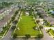 Aerial view of community park with covered picnic tables, green space, and winding walking trails at 13227 Great Plains Dr, Riverview, FL 33579