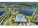 Aerial view of neighborhood amenities including community pool, playground, and scenic walking trails around a beautiful lake at 13511 Fladgate Mark Dr, Riverview, FL 33579