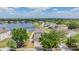 Aerial view of the home, showing the fenced backyard and nearby lake at 13511 Fladgate Mark Dr, Riverview, FL 33579