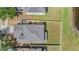 Aerial view of a single-Gathering home with a fenced backyard and mature trees, adjacent to a pond at 13511 Fladgate Mark Dr, Riverview, FL 33579