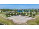 Outdoor amphitheater surrounded by lush greenery and a scenic lake, ideal for community events and gatherings at 13511 Fladgate Mark Dr, Riverview, FL 33579