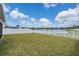 Spacious backyard with lush green lawn and view of the lake beyond the fence at 13511 Fladgate Mark Dr, Riverview, FL 33579