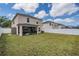 Large backyard with green lawn, screened patio, and white fence at 13511 Fladgate Mark Dr, Riverview, FL 33579