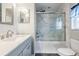Bathroom featuring marble countertops, a single sink, modern fixtures, and a glass-enclosed shower with marble surround at 13511 Fladgate Mark Dr, Riverview, FL 33579