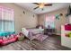 bedroom with colorful decor, wood-look floors, and playful accents at 13511 Fladgate Mark Dr, Riverview, FL 33579