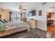 Bedroom featuring a ceiling fan, large windows, and light wood furniture, with a TV mounted on the wall at 13511 Fladgate Mark Dr, Riverview, FL 33579