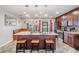 A kitchen featuring an island with barstool seating, pendant lighting, stainless appliances, and custom cabinets at 13511 Fladgate Mark Dr, Riverview, FL 33579