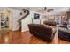 The living room has hardwood floors, leather couches, and an open layout to the kitchen, creating a welcoming space at 13511 Fladgate Mark Dr, Riverview, FL 33579