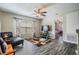 Comfortable living room with a ceiling fan, TV, and an accent chair, with view to the bedroom at 13511 Fladgate Mark Dr, Riverview, FL 33579