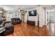 The living room features hardwood floors, two leather couches, and staircase, creating a cozy and inviting atmosphere at 13511 Fladgate Mark Dr, Riverview, FL 33579