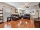 The living room features hardwood floors, two leather couches, ceiling fan, and ample space for entertaining at 13511 Fladgate Mark Dr, Riverview, FL 33579