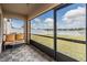 Screened patio with outdoor seating and view of fenced yard and lake at 13511 Fladgate Mark Dr, Riverview, FL 33579