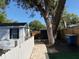 Backyard featuring a storage shed, a wooden fence, and a brick pathway, showcasing a private and practical outdoor space at 1408 San Juan Ct, Clearwater, FL 33756
