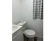 Cozy bathroom featuring a white toilet and sink and window at 1408 San Juan Ct, Clearwater, FL 33756