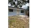 Charming single-story home featuring a welcoming front entrance, complemented by adjacent windows and simple landscaping at 1408 San Juan Ct, Clearwater, FL 33756