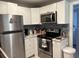 Modern kitchen featuring white cabinetry and stainless steel appliances at 1408 San Juan Ct, Clearwater, FL 33756