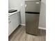 Small kitchen featuring gray refrigerator and marble countertops at 1408 San Juan Ct, Clearwater, FL 33756