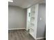 Bright living room featuring hardwood floors and built-in shelving for ample storage and organization at 1408 San Juan Ct, Clearwater, FL 33756