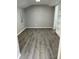 Living space featuring gray wood-look floors and built-in shelving at 1408 San Juan Ct, Clearwater, FL 33756