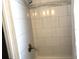 Shower stall featuring neutral-toned tiles and a chrome shower head at 1408 San Juan Ct, Clearwater, FL 33756