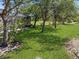 Lush backyard view with mature trees and a screened-in lanai at 14319 Morristown Ave, Port Charlotte, FL 33981