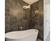 Modern bathroom showcasing a freestanding tub, stylish tile walls and contemporary light fixture at 14319 Morristown Ave, Port Charlotte, FL 33981