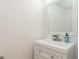 Bathroom with white vanity, modern faucet, decorative mirror, and neutral wall color at 14319 Morristown Ave, Port Charlotte, FL 33981