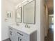 Bathroom featuring double vanity, square mirrors, gray cabinets, and modern finishes at 14319 Morristown Ave, Port Charlotte, FL 33981