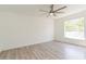 Bright bedroom featuring hardwood floors, large windows, and a modern ceiling fan at 14319 Morristown Ave, Port Charlotte, FL 33981