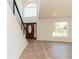 Bright entryway features a modern staircase with metal railings and a decorative wood front door at 14319 Morristown Ave, Port Charlotte, FL 33981