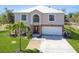 Well-maintained two-story home with a white roof and a manicured lawn at 14319 Morristown Ave, Port Charlotte, FL 33981