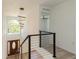 Foyer with dark hardwood front door, modern railing, and large window, providing ample natural light at 14319 Morristown Ave, Port Charlotte, FL 33981